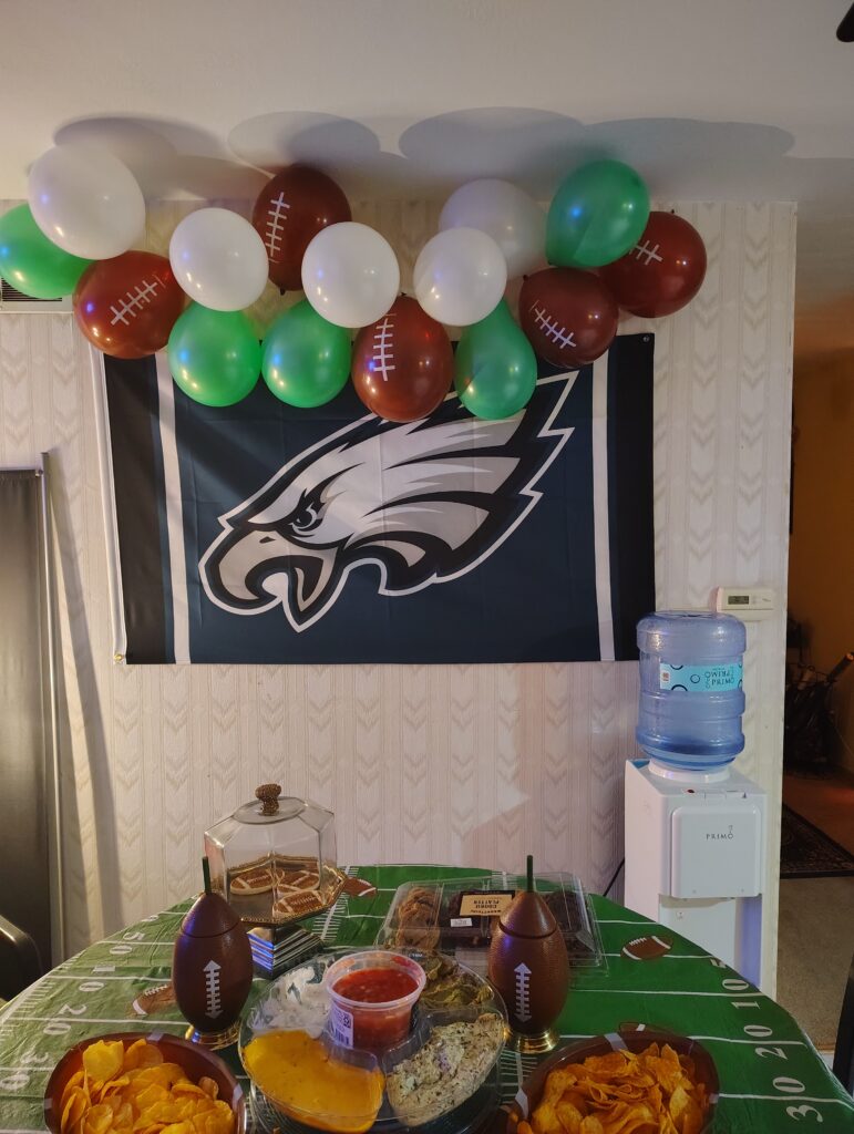 eagles banner with small balloon garland & snack table