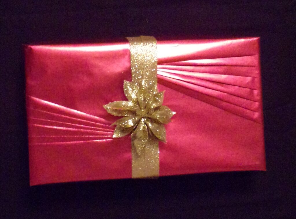 Accordian Red Gift With Gold Glitter Ribbon Gold Flower Bow 1024x758