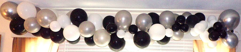 Black, white, grey, and silver balloon arch
