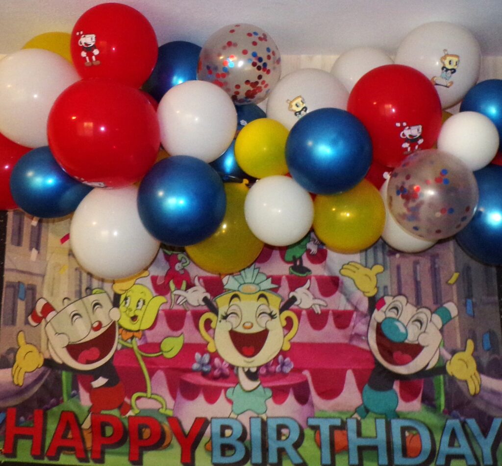 Cuphead birthday banner with red, white, blue, and yellow balloon arch